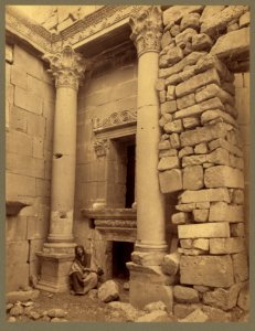 Man seated at base of column outside entrance to building, al Bara) - Bonfils LCCN2004670495