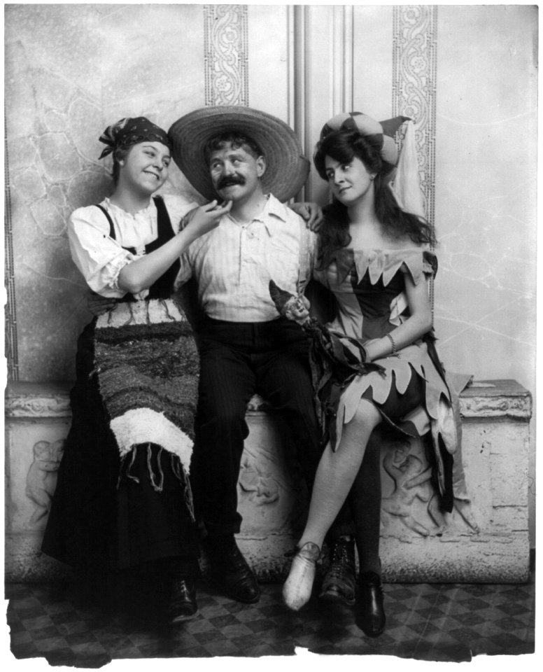 Man seated between 2 flirtatious women LCCN2003675187