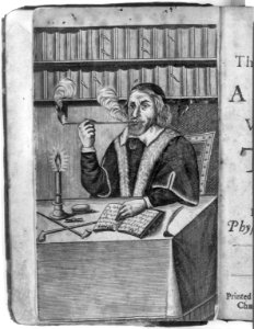 Man smoking a long pipe, seated at table with book, candle and 2 more long pipes LCCN2006681232