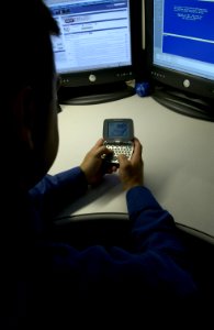 Man uses personal communications device photo