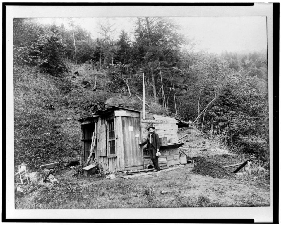 Man, identified as the postmaster, standing outside of shack serving as the Searsburg post office in 1914 LCCN96501477