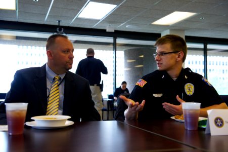 Man in suit talks to law enforcement explorer photo