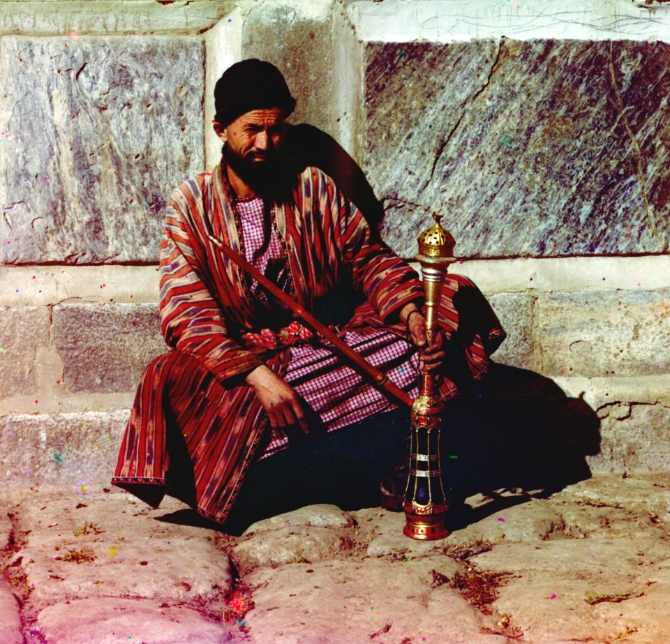 Man sitting and holding a hookah