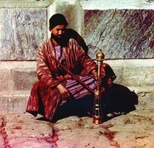 Man sitting and holding a hookah