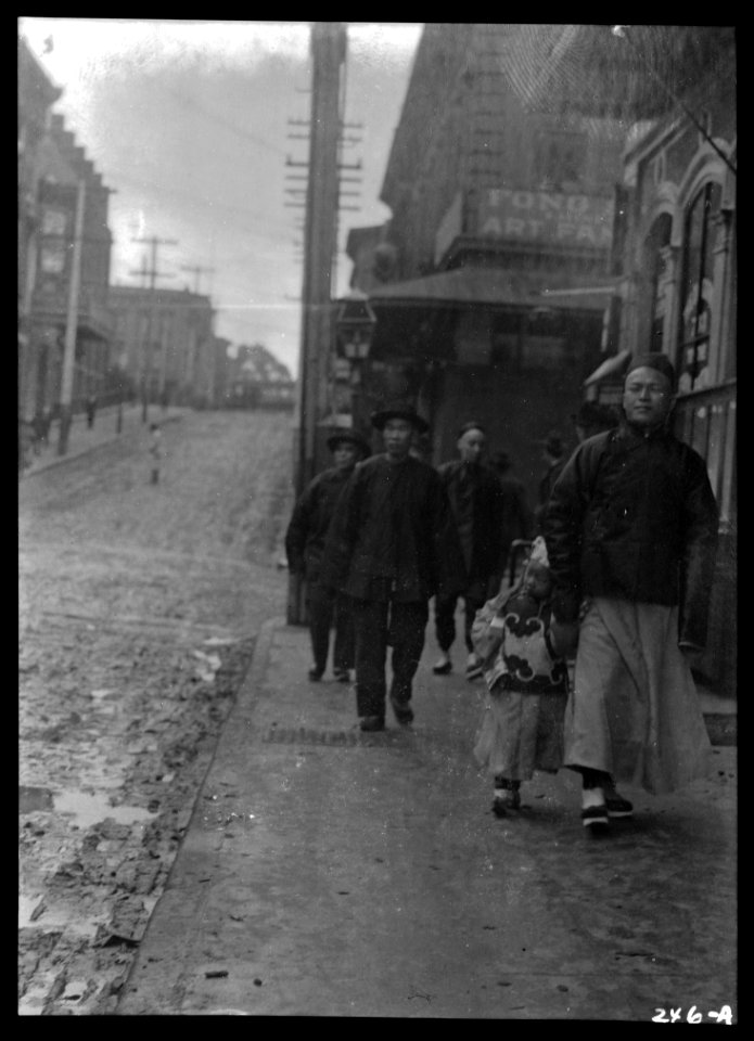Man and a boy walking down a sidewalk with other people, Chinatown, San Francisco LOC agc.7a09024