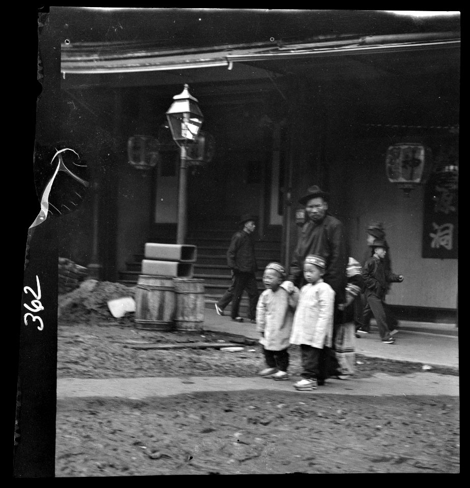 Man and two children crossing a street, Chinatown, San Francisco LOC agc.7a09055