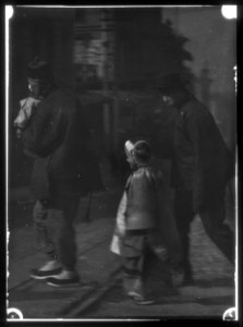 Man carrying a child accompanied by a man and another child, Chinatown, San Francisco LOC agc.7a55093