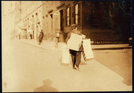 Man carrying load of caps made at home to factory, 9-11 University Place, -- Feldstein's. LOC nclc.04185