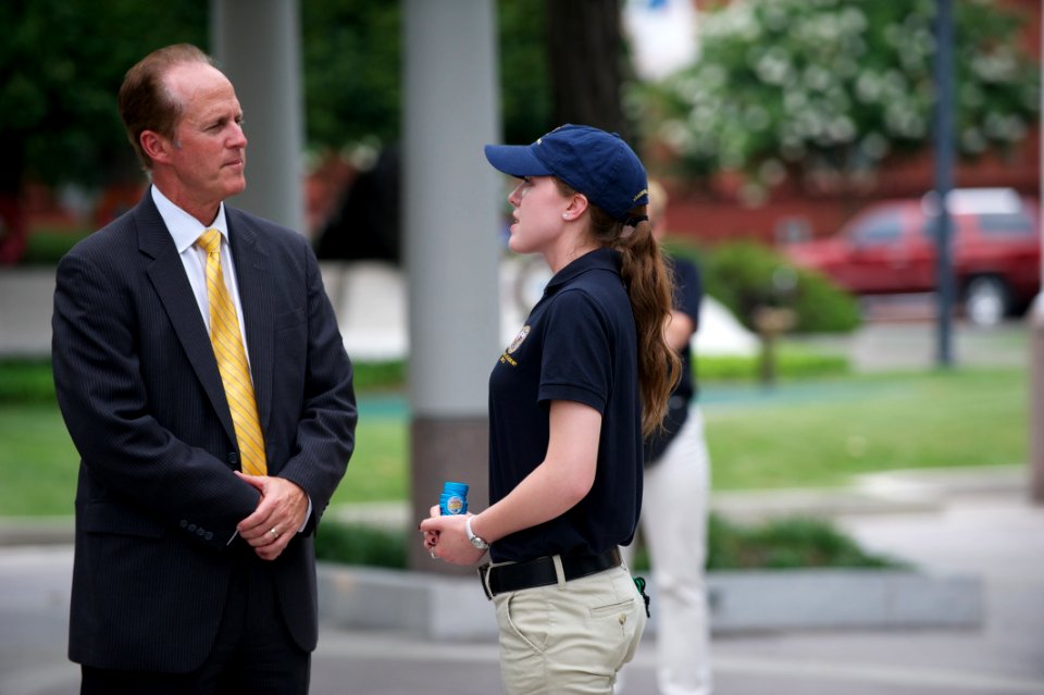 Man converses with law enforcement explorer