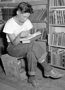 Man reading book in library at Manzanar Relocation Center, Manzanar, California. A barrack building has been turned into a library . . . - NARA - 538175 (cropped)