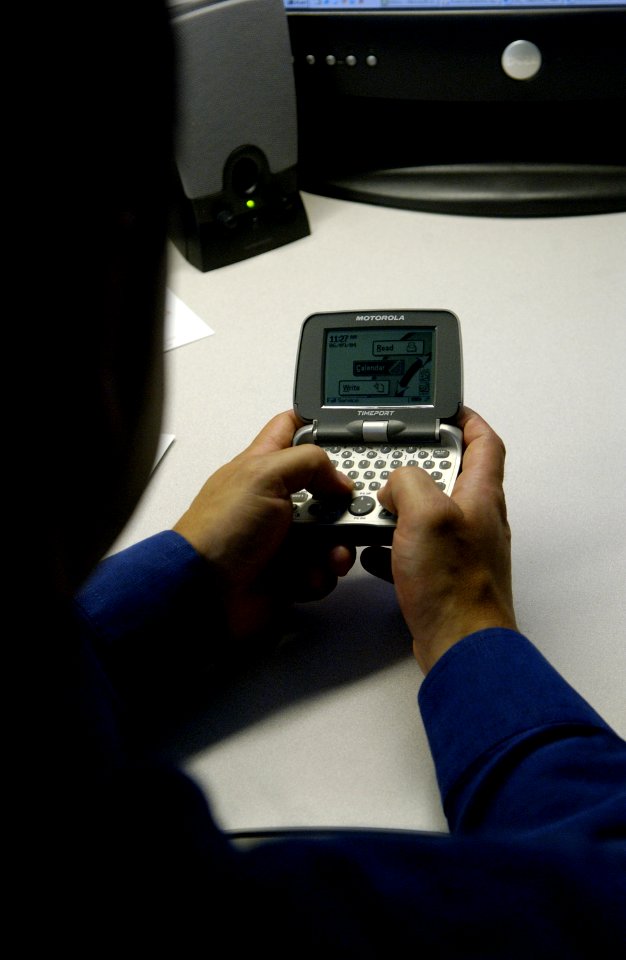 Man uses personal communications device (1)