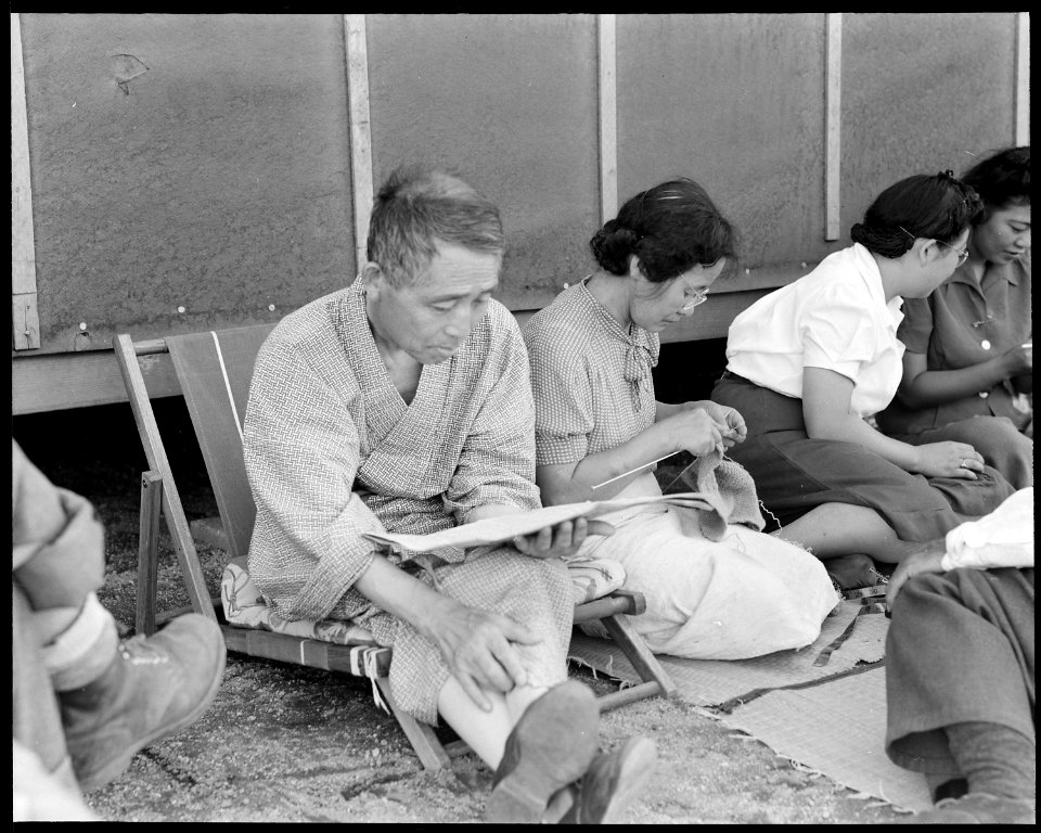 Manzanar Relocation Center, Manzanar, California. Evacuees of Japanese ancestry rest in the cool of . . . - NARA - 538071