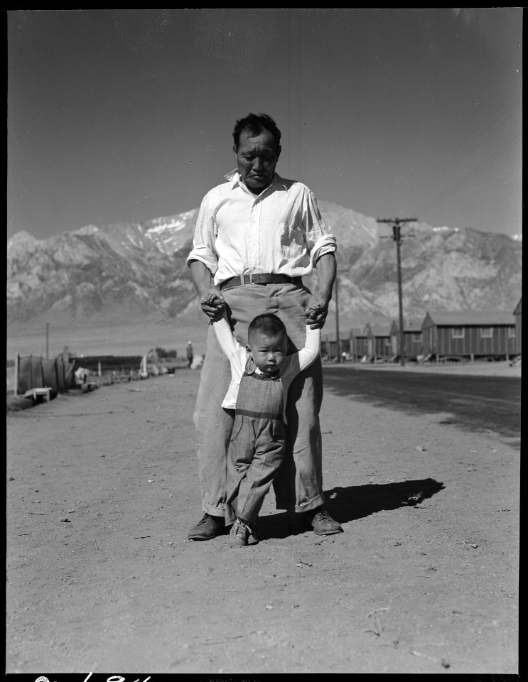 Manzanar Relocation Center, Manzanar, California. Grandfather of Japanese ancestry teaching his lit . . . - NARA - 537991