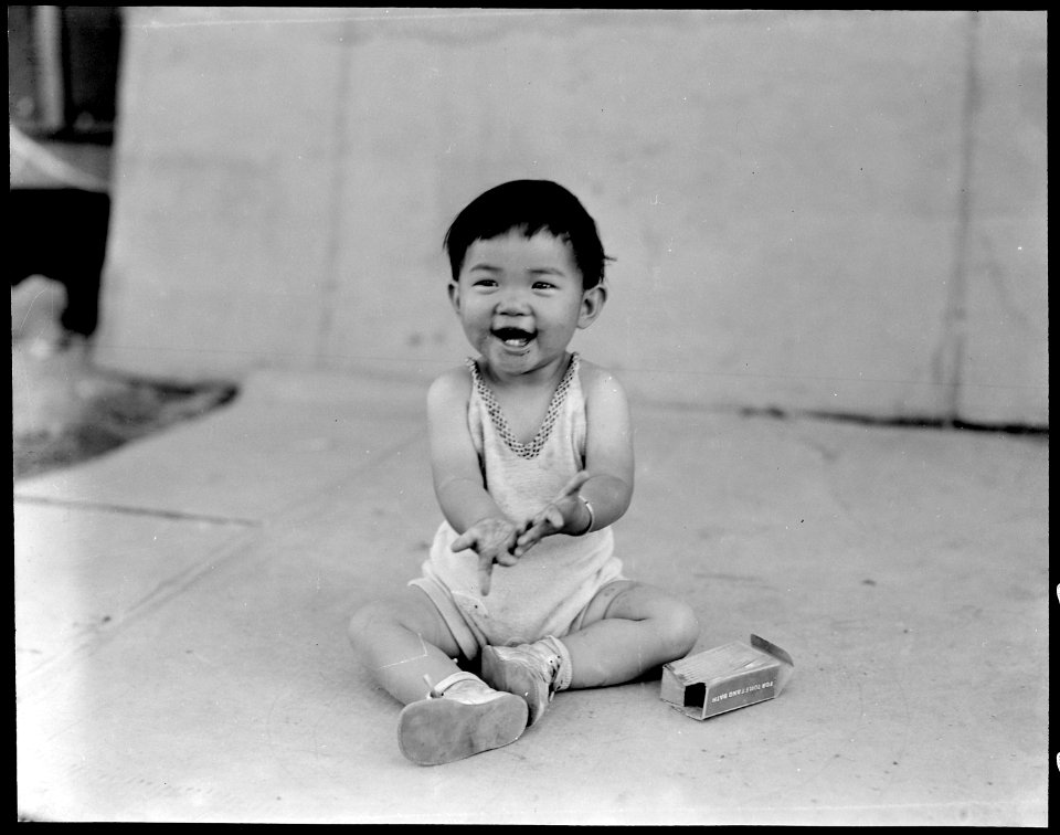 Manzanar Relocation Center, Manzanar, California. Little evacuee of Japanese ancestry in a happy mo . . . - NARA - 538012
