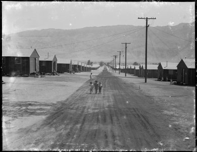 Manzanar Relocation Center, Manzanar, California. Street scene looking east toward the Inyo Mountai . . . - NARA - 538121