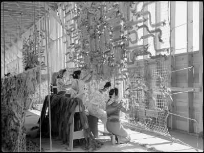 Manzanar Relocation Center, Manzanar, California. Making camouflage nets for the War Department. T . . . - NARA - 538107 photo