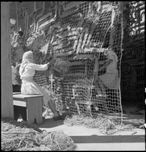 Manzanar Relocation Center, Manzanar, California. Making camouflage nets for the War Department. T . . . - NARA - 538111 photo
