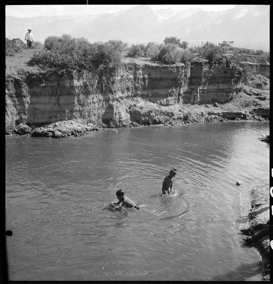 Manzanar Relocation Center, Manzanar, California. Small evacuee boys enjoying a swim in the mountai . . . - NARA - 538080