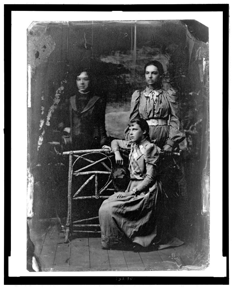 Marian Daisy Bell, left, and Elsie May Bell, right, standing, with an unidentified friend, seated LCCN2006688338