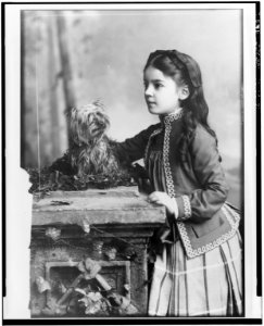 Marian Hubbard Daisy Bell, three-quarter length portrait, at eight years of age, standing, facing left, with dog LCCN00649941