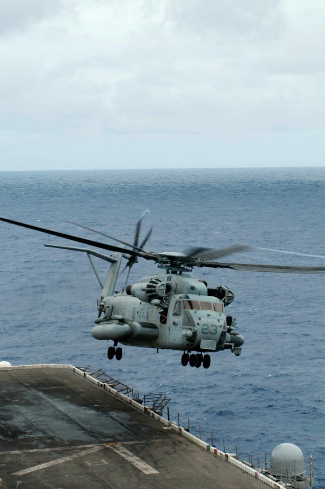 Marines fast rope onto flight deck of USS Peleliu 121005-N-KR526-020