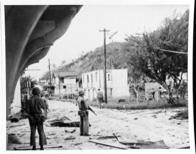 Marines in ruins of Guam town, 1944 photo