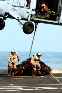 Marines run after connecting cargo to an MH-60S. (8428932825) photo