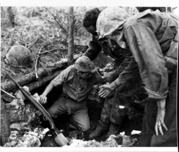 Marines coax a Japanese Navy man into surrendering on Guam, July 1944