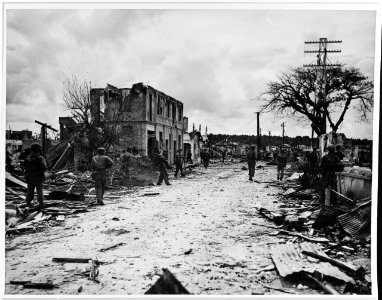Marines enter the ruins of Hagåtña, Guam, on July 31, 1944