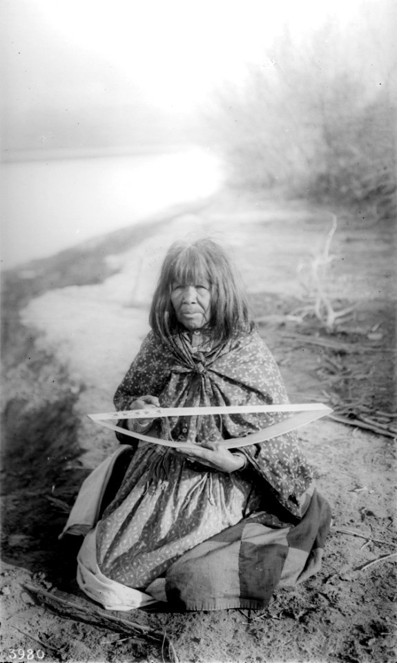 Mojave Indian woman making a beadwork belt with heart-shaped designs, ca.1900 (CHS-3980)