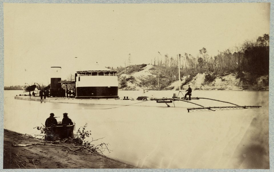 Monitor in Trent's Reach, James River, Va. showing torpedo finder at bow. Butlers Crow's Nest and battery on bank of river LCCN2013646198
