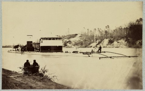 Monitor in Trent's Reach, James River, Va. showing torpedo finder at bow. Butlers Crow's Nest and battery on bank of river LCCN2013646198
