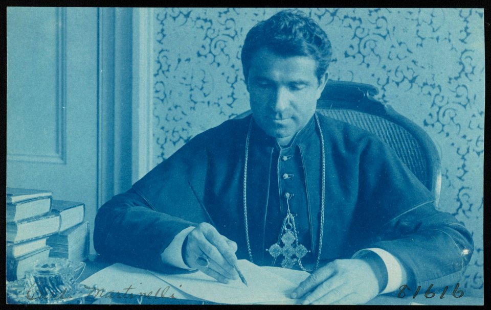 Monsignore Martinelli, later Cardinal Martinelli, writing at desk LCCN2012648189