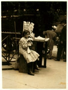 Minnie Paster, 10 years old. Tending stand at Bowery & Bond. LOC nclc.03642