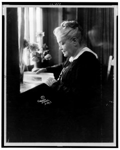Miss Laura Clay, half-length portrait, seated at desk reading, facing left LCCN99401083