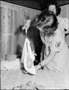 Miss Hazel Jamison, R.N., employed by company, weighs baby of Aubrey Cook, miner, who lives outside company housing... - NARA - 540950