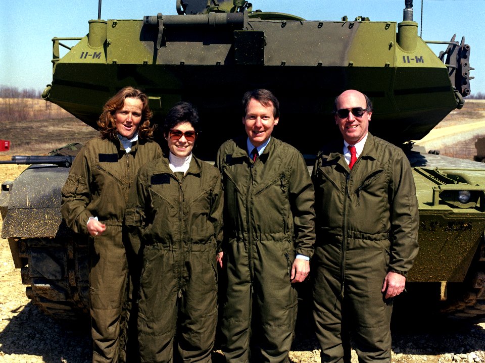 Mitch McConnell and members of his staff gather for a photograph near an M1 Abrams main battle tank