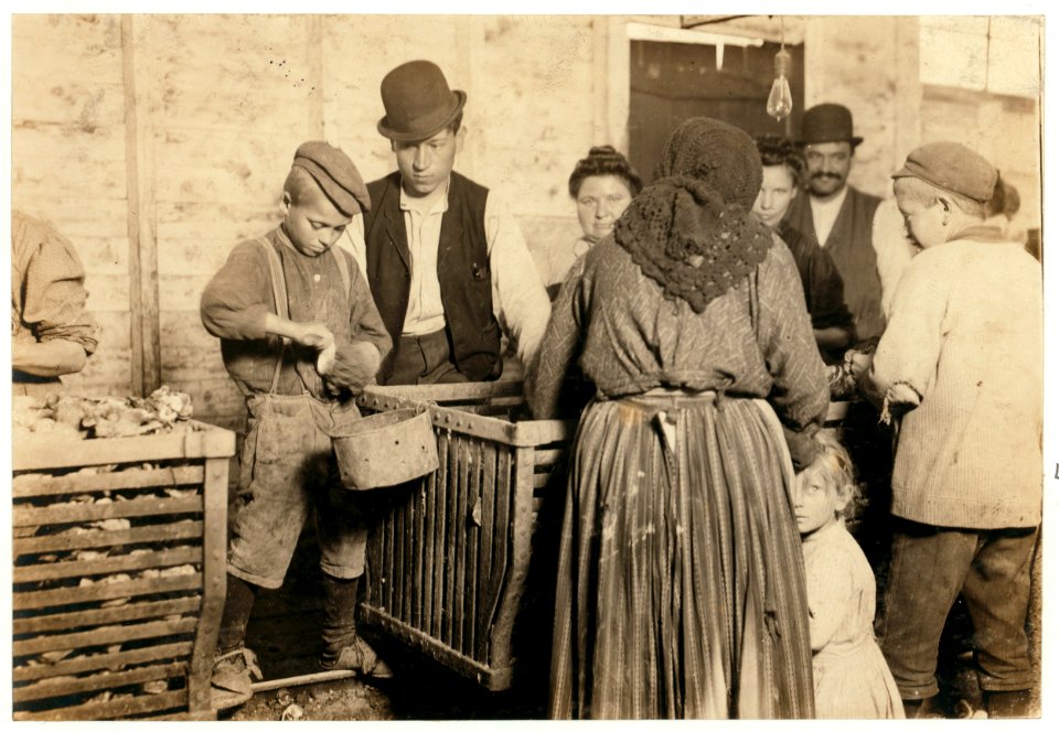 Nine-year-old Johnnie and the shucking-boss. He is also a padrone. For four years has brought these people from Baltimore. LOC cph.3c19790