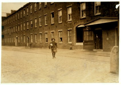 Noon, Saturday, May 22, 1909. One of the many young girls who are working in Amoskeag Mills, Manchester, N.H. I saw them (and many others smaller) working at the spinning frames. LOC cph.3b18631