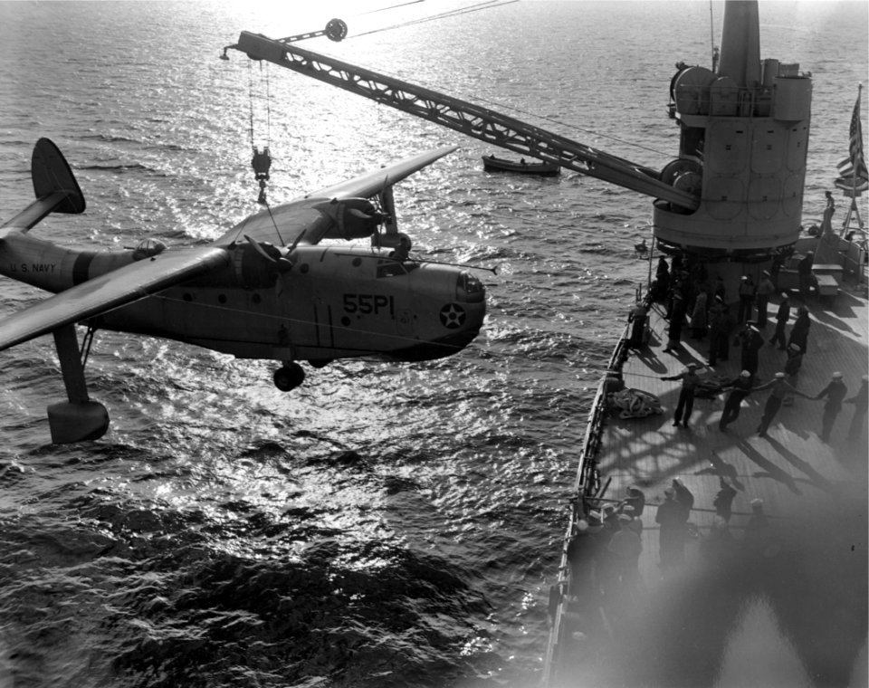 Martin PBM-1 Mariner of VP-55 is hoisted aboard USS Albemarle (AV-5), in 1941 (NNAM.1986.014.022)