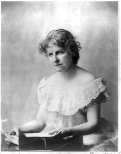 Mary Eleanor Wilkins Freeman, 1852-1930, 1-2 length portrait, seated at small desk or table, facing left LCCN2005677886
