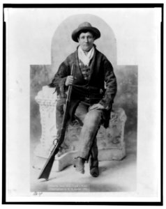 Martha Canary, 1852-1903, (Calamity Jane), full-length portrait, seated with rifle as General Crook's scout LCCN2005689345