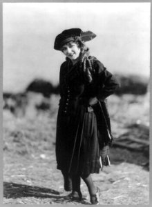 Mary Pickford, 1893-, full-length, standing, facing left, left hand on hip LCCN2005679810