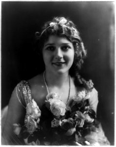 Mary Pickford, 1893-, head and shoulders portrait, holding flowers, facing front LCCN2005679811