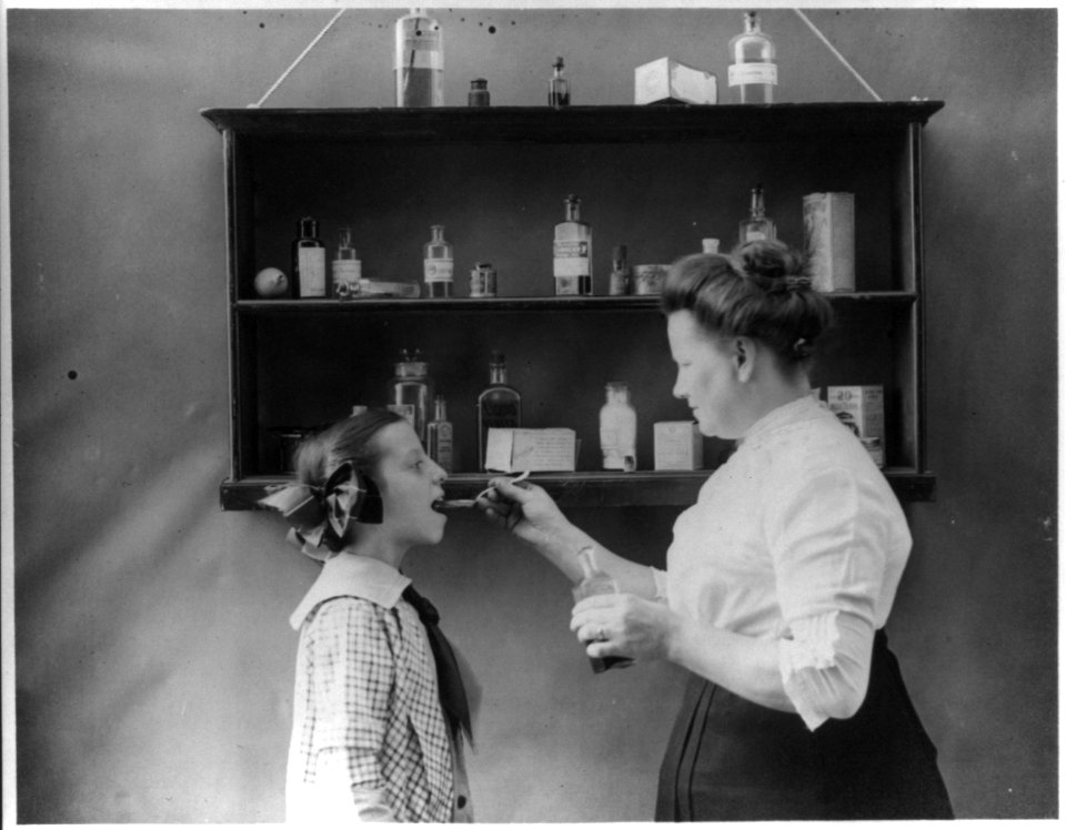 Mother giving medicine to child LCCN2012645695