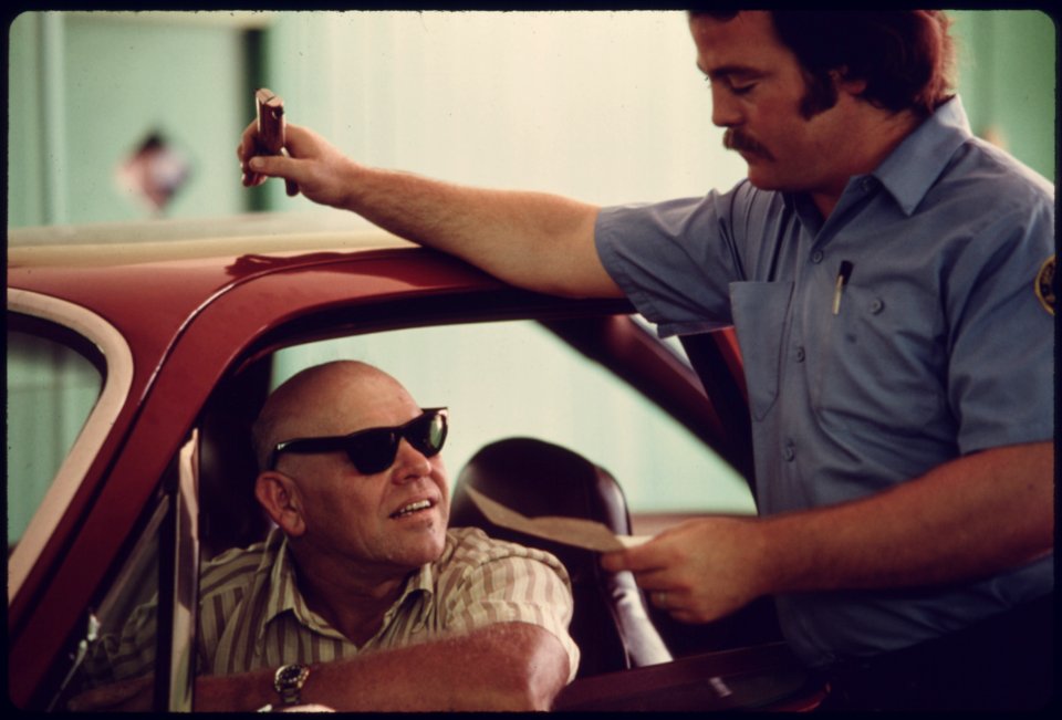 Motorist and Public Works Department Employee Discuss the Results of the Car's Performance after Testing at an Auto Emission Inspection Station in Norwood, Ohio...08-1975 (4265784559)