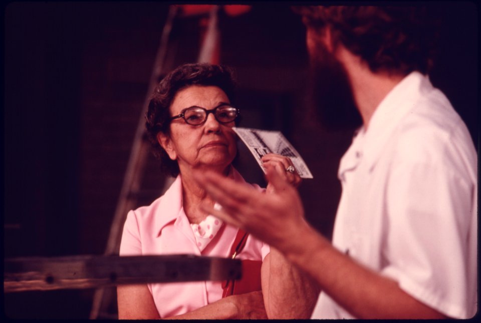 Motorist, Left, Listens to a City Employee Explain the Exhaust Emissions Test at an Auto Emission Inspection Station in Downtown Cincinnati, Ohio 09-1975 (4265794965)