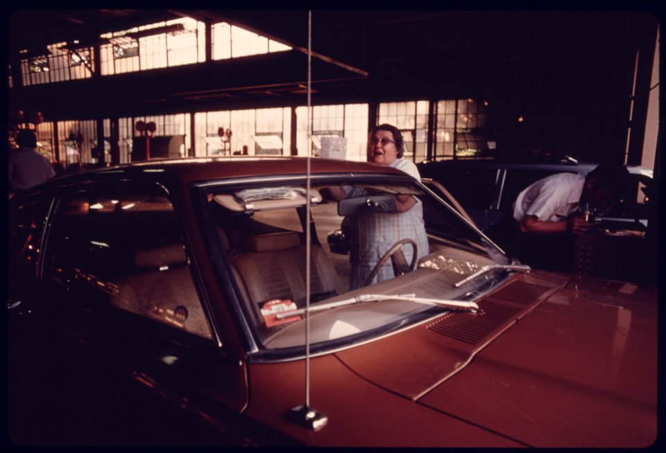 Motorist Is Happy after a 1976 Inspection Seal Was Pasted to the Windshield after Her Car Successfully Passed Testing at an Auto Emission Inspection Station in Downtown Cincinnati, Ohio...08-1975 (4265797509)