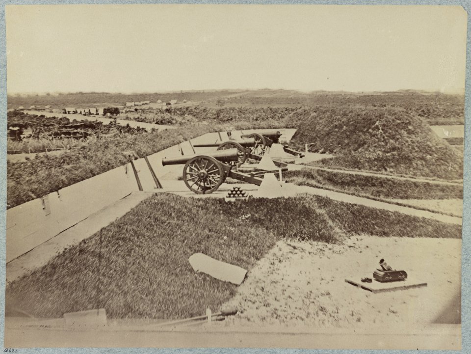 Mounted guns and ammunition around the perimeter of a fort, and tents in the background LCCN2014646405