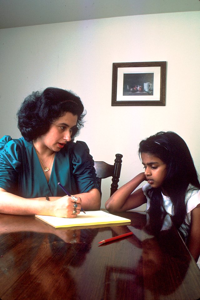 Mother and daughter seated at table
